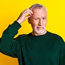 Man scratching his head in confusion