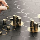 Hand arranges coins on hexagonal grid