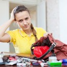 Woman searching purse for lost aligner