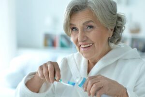 senior woman brushing her teeth