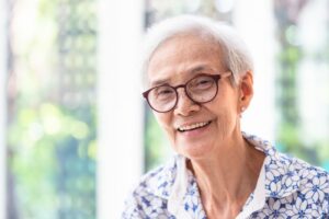 elderly woman with glasses smiling 